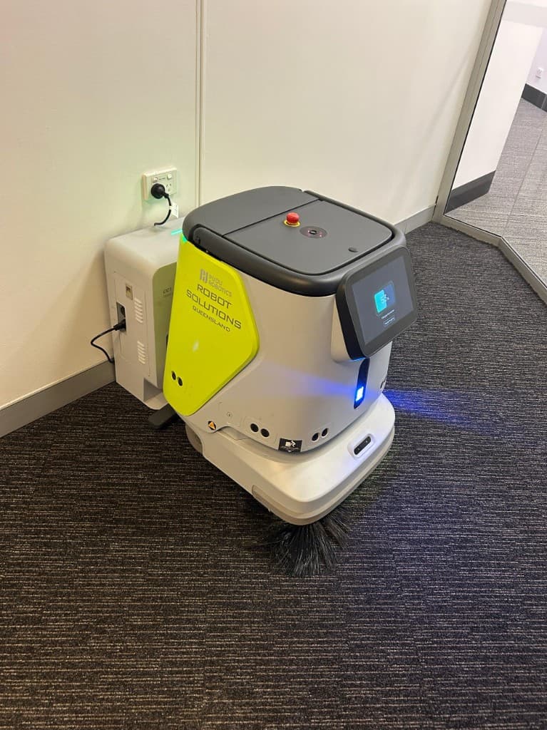 Commercial cleaning robot docked at charging station