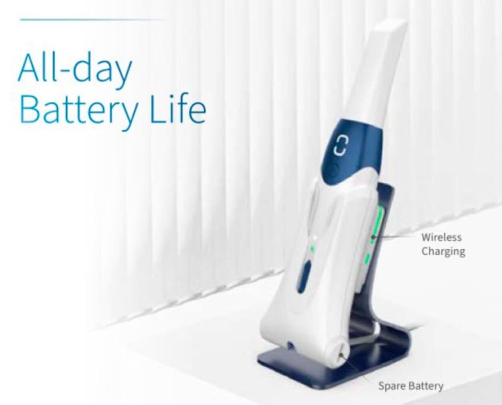 Handheld diagnostic scanner docked on a wireless charging cradle